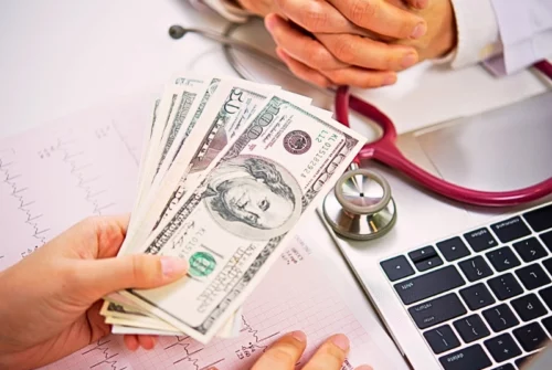 Medical Debt and Bankruptcy in Las Vegas: A path to Financial Relief 1 Patient giving money to medical doctor in hospital setting. medical debt and bankruptcy